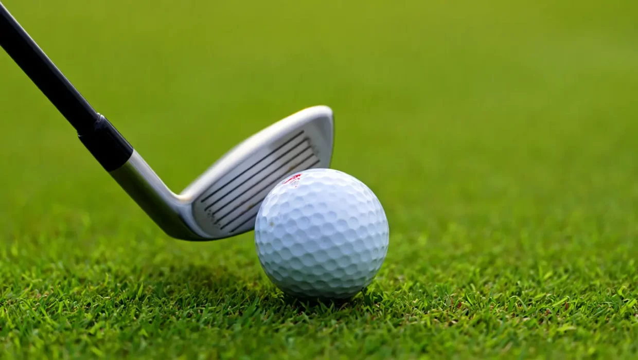 golf club to hit the ball
